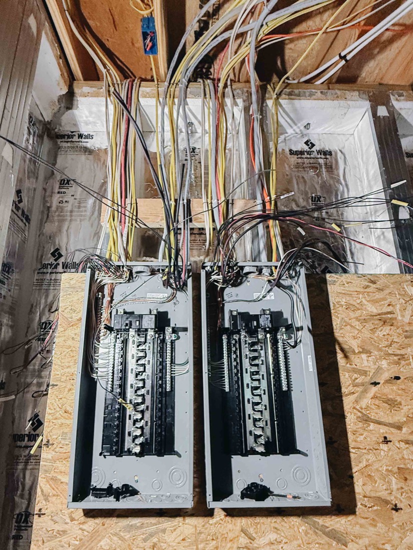 Main breaker panel before — cluttered and disorganized wiring